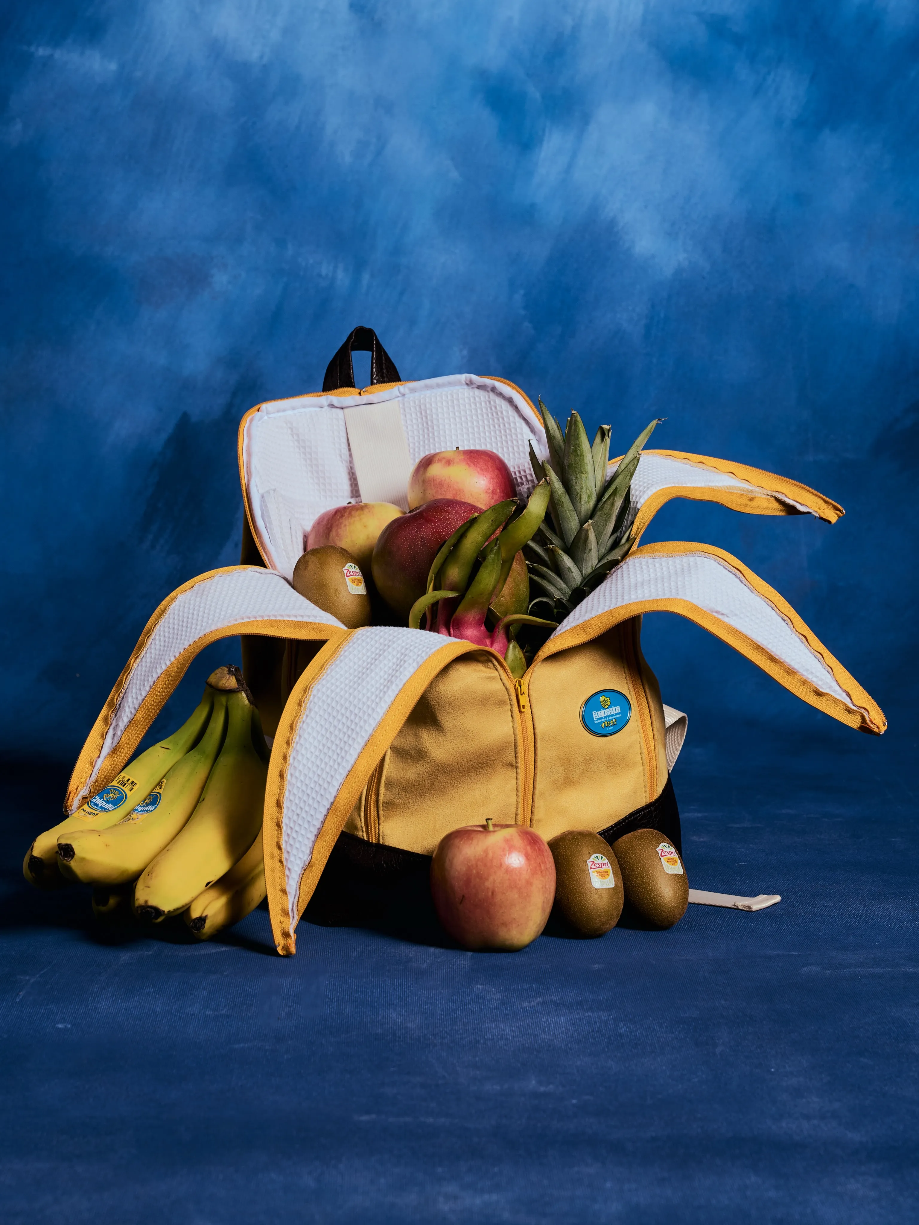 The Banackpack unzipped and peeled open, filled with fruit
